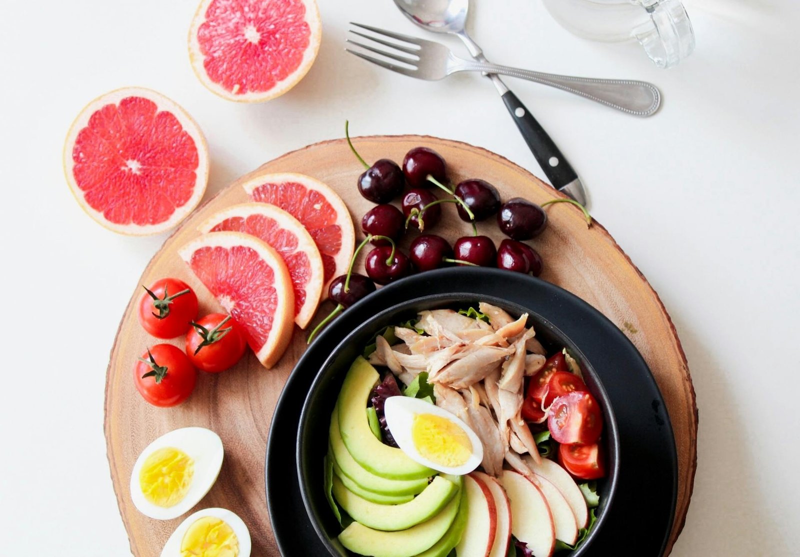 Overhead view of an anti-inflammatory superfoods bowl with blueberries, walnuts, avocado, spinach, chia seeds and olive oil