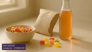 Brightly coloured breakfast cereal, boiled sweets and a fizzy drink on a kitchen counter beside a food packet